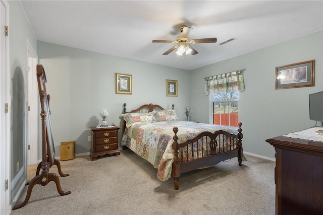 carpeted bedroom featuring visible vents, baseboards, and ceiling fan