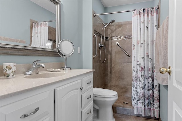 full bathroom featuring vanity, toilet, and a tile shower