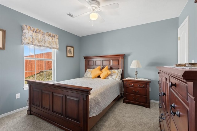 bedroom featuring ceiling fan, baseboards, visible vents, and light carpet