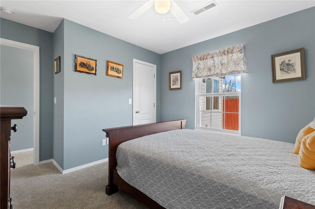 carpeted bedroom with baseboards, visible vents, and ceiling fan