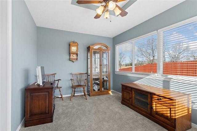 living area with baseboards, carpet, and ceiling fan