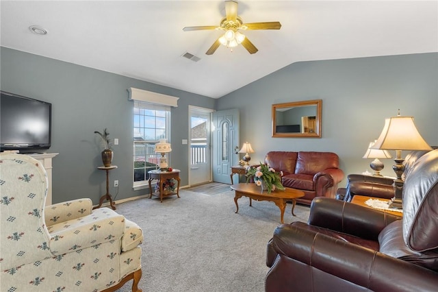 living area with visible vents, lofted ceiling, carpet floors, baseboards, and ceiling fan