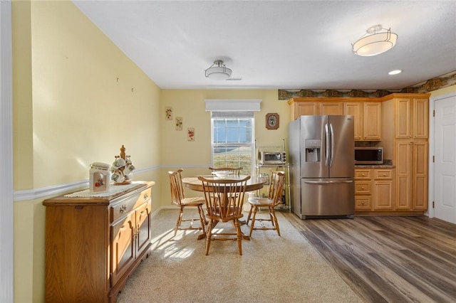 dining room with wood finished floors and a toaster