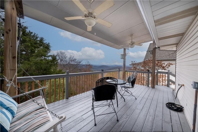 wooden terrace featuring a ceiling fan