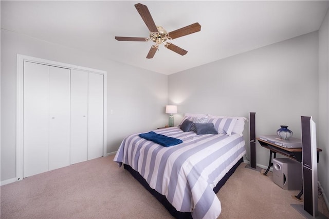 carpeted bedroom featuring a closet and ceiling fan