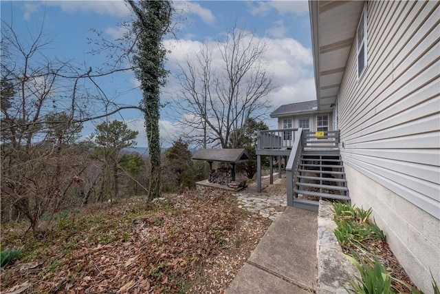 view of yard featuring stairway and a deck