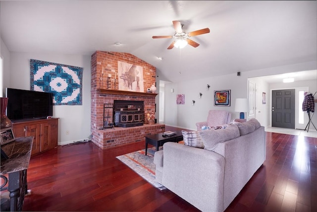 living room featuring vaulted ceiling, baseboards, ceiling fan, and wood finished floors