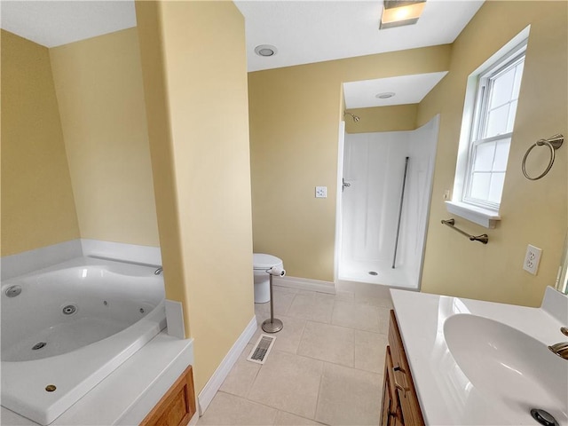 full bathroom featuring toilet, vanity, tile patterned flooring, baseboards, and a whirlpool tub