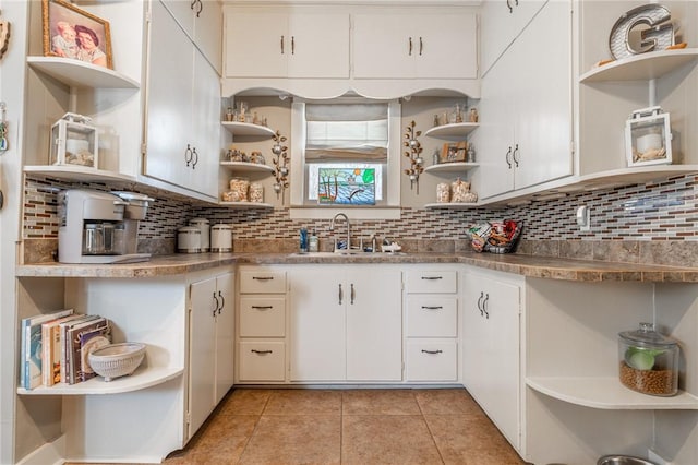 kitchen with open shelves, backsplash, and a sink