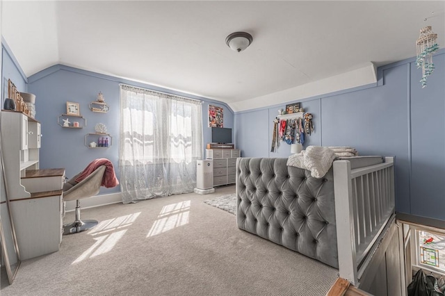 carpeted bedroom with lofted ceiling