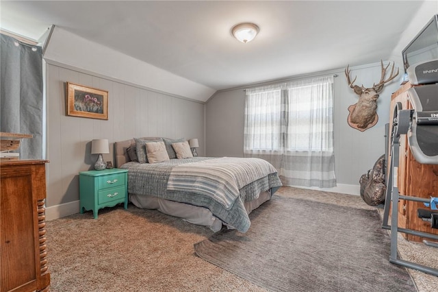 carpeted bedroom with vaulted ceiling and baseboards