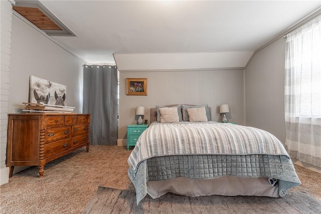 bedroom with multiple windows, lofted ceiling, and carpet flooring