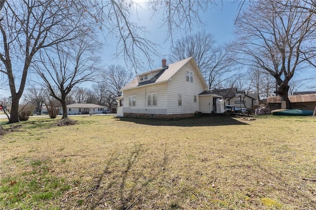 view of property exterior with a lawn and a chimney