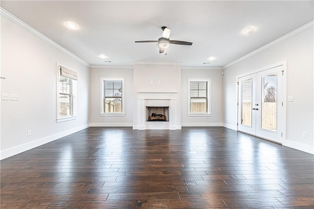 unfurnished living room with a fireplace, crown molding, french doors, and dark wood-style flooring