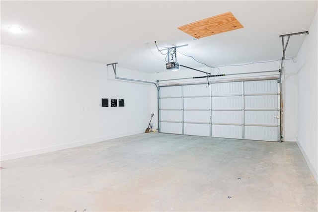 garage with baseboards and a garage door opener