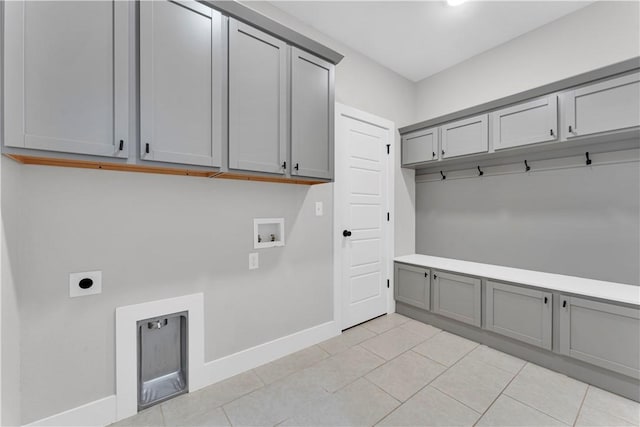 mudroom with baseboards and light tile patterned floors