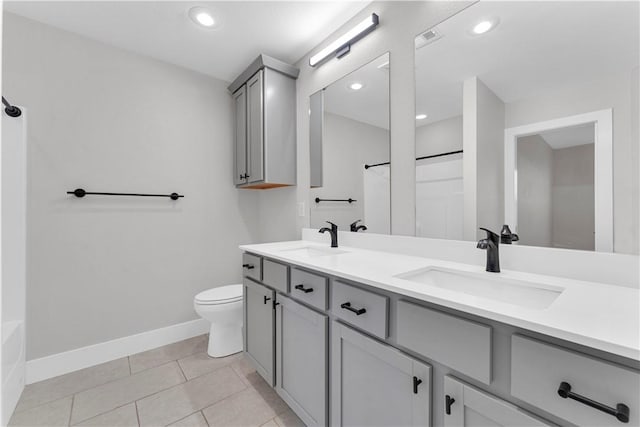 full bathroom with a sink, baseboards, toilet, and visible vents