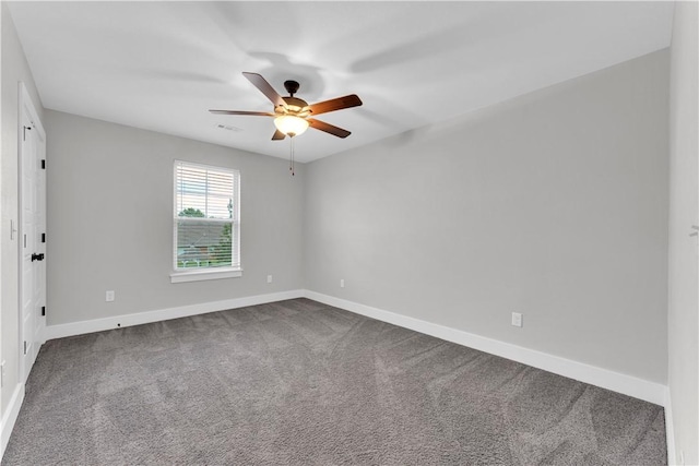 empty room with baseboards, ceiling fan, and dark carpet