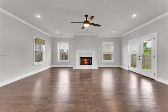 unfurnished living room with ceiling fan, french doors, dark wood-type flooring, and a wealth of natural light