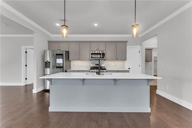 kitchen with light countertops, gray cabinets, stainless steel appliances, and a sink