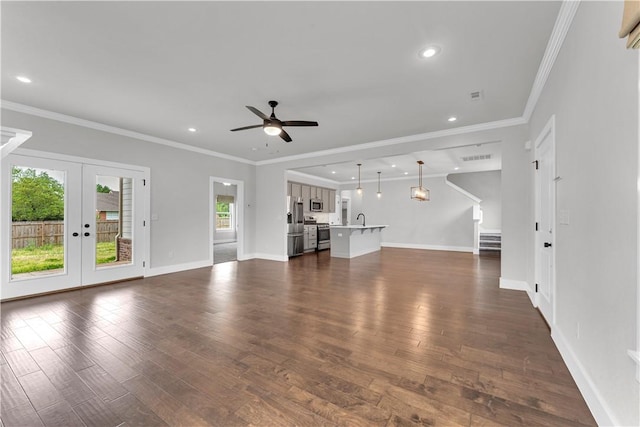 unfurnished living room featuring french doors, dark wood finished floors, ceiling fan, and stairs
