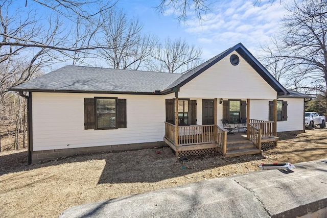 ranch-style home featuring a porch and a shingled roof