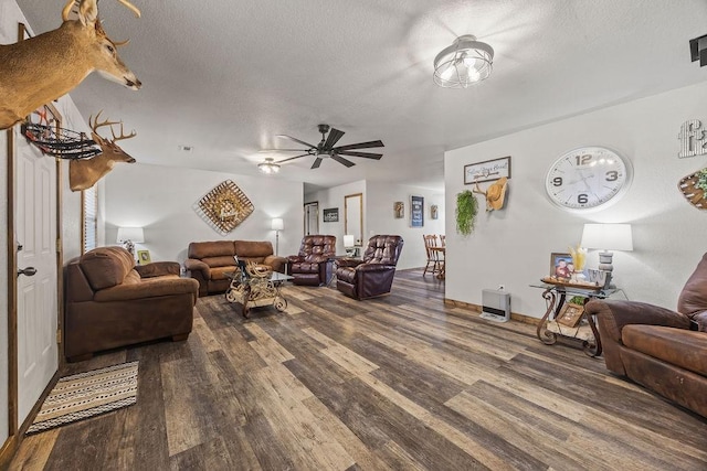 living room with visible vents, a textured ceiling, and wood finished floors