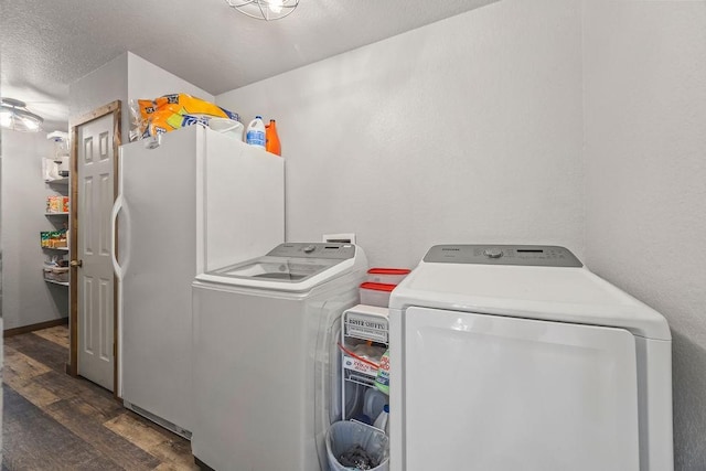 laundry area with separate washer and dryer, wood finished floors, laundry area, and a textured ceiling