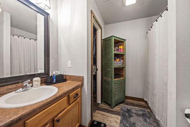 full bath with vanity and wood finished floors