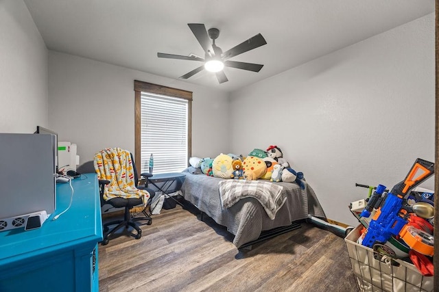 bedroom featuring wood finished floors and ceiling fan