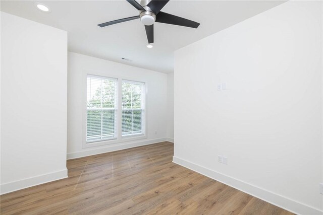 unfurnished room featuring recessed lighting, ceiling fan, baseboards, and wood finished floors