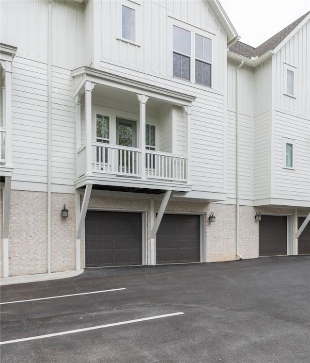 view of front of house featuring board and batten siding, driveway, and a garage