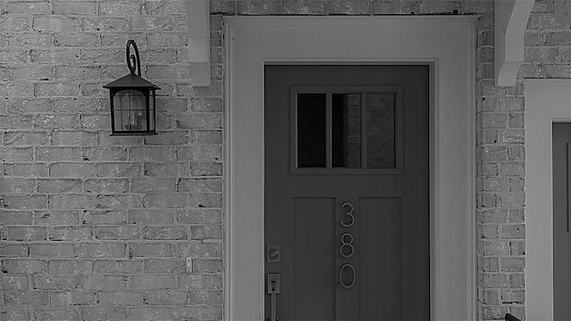 entrance to property with brick siding