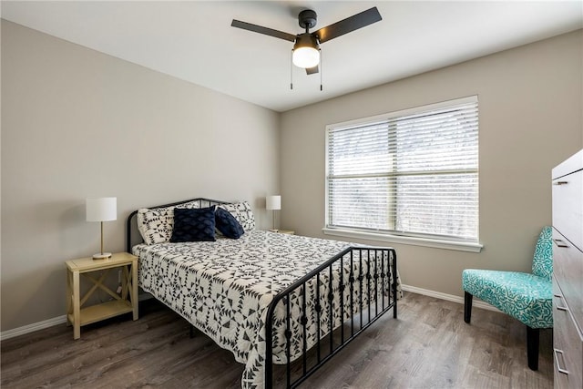 bedroom with baseboards, wood finished floors, and a ceiling fan