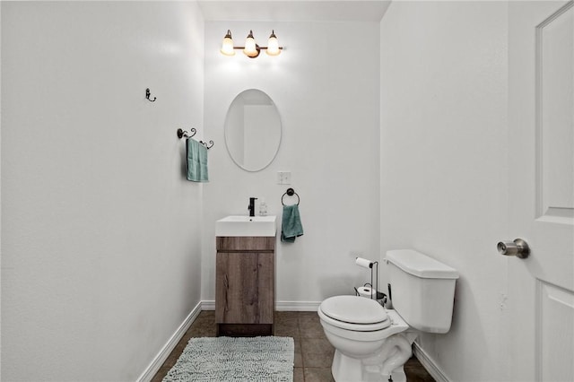 bathroom featuring tile patterned flooring, toilet, vanity, and baseboards