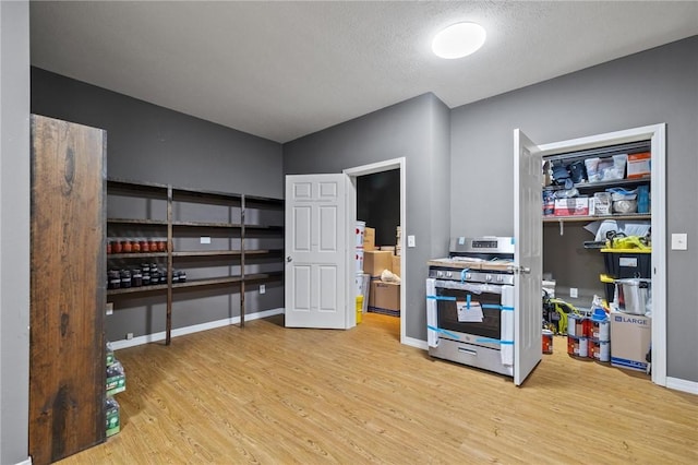 interior space featuring baseboards and wood finished floors