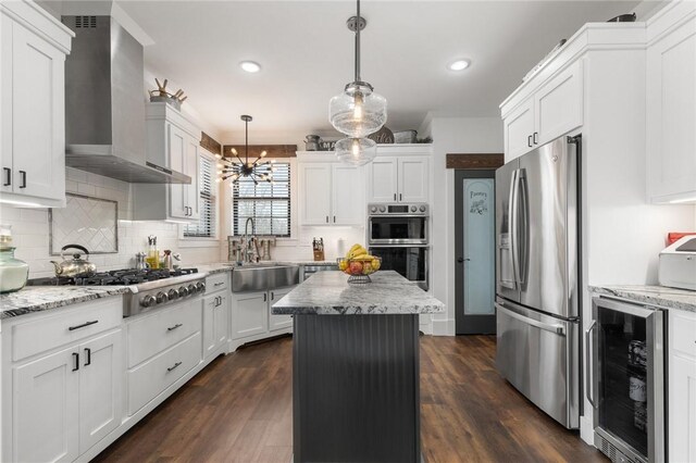 kitchen with wine cooler, stainless steel appliances, white cabinetry, wall chimney exhaust hood, and a sink