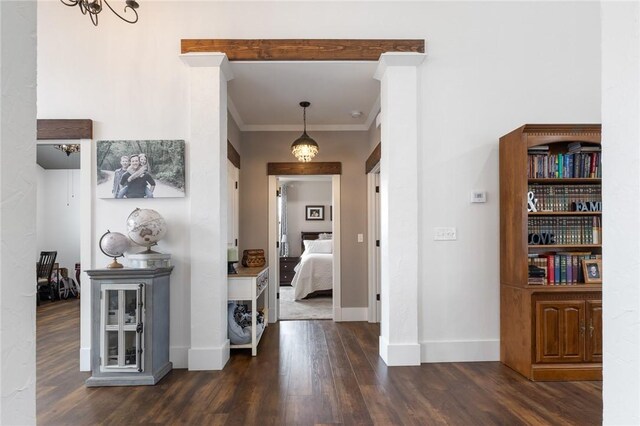 corridor with baseboards, dark wood-style flooring, and crown molding