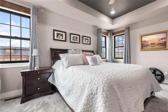 bedroom featuring a ceiling fan, visible vents, baseboards, recessed lighting, and light carpet