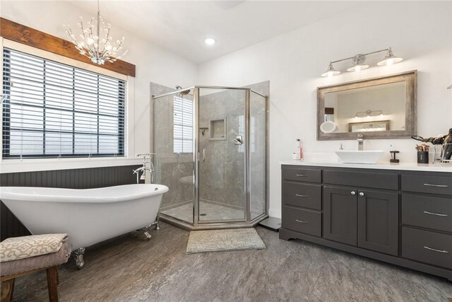 full bath with wood finished floors, a freestanding bath, a stall shower, and vanity