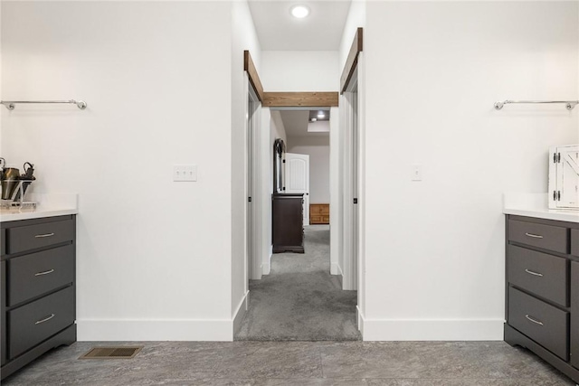 bathroom with baseboards and visible vents