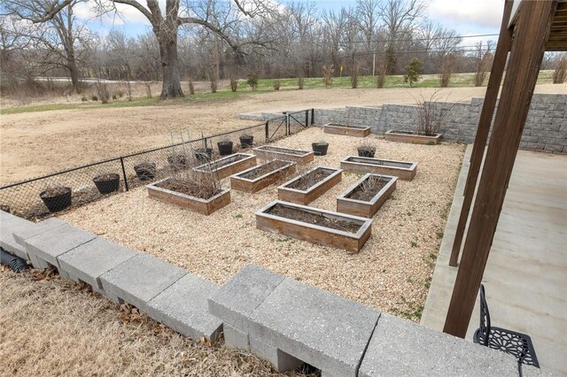 view of yard featuring a vegetable garden and fence