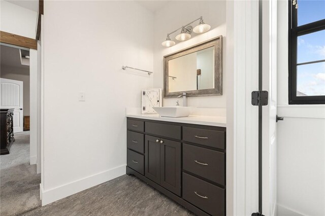 bathroom featuring baseboards and vanity