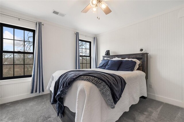 carpeted bedroom featuring visible vents, baseboards, and ceiling fan