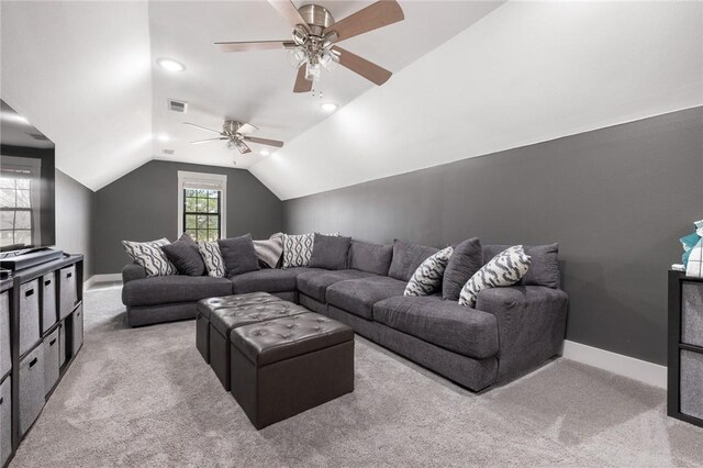 living room featuring lofted ceiling, baseboards, visible vents, and light carpet