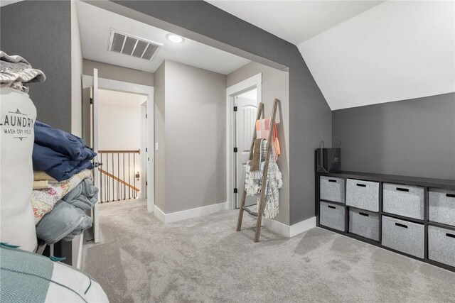 interior space featuring vaulted ceiling, baseboards, and visible vents