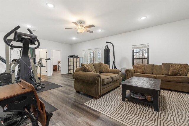 living area with recessed lighting, a ceiling fan, and wood finished floors