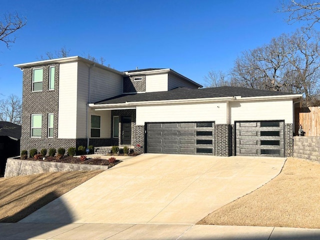 view of front of house featuring a garage, brick siding, driveway, and fence