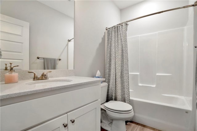 full bathroom featuring vanity, toilet, wood finished floors, and shower / bath combo