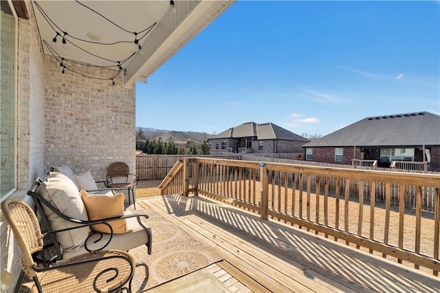 deck with a fenced backyard and a residential view